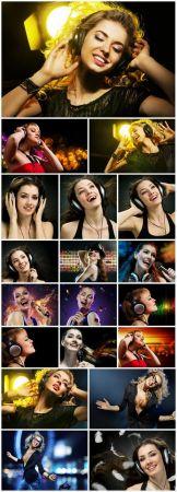 DesignOptimal - Girls with headphones listening to music and singing stock photo